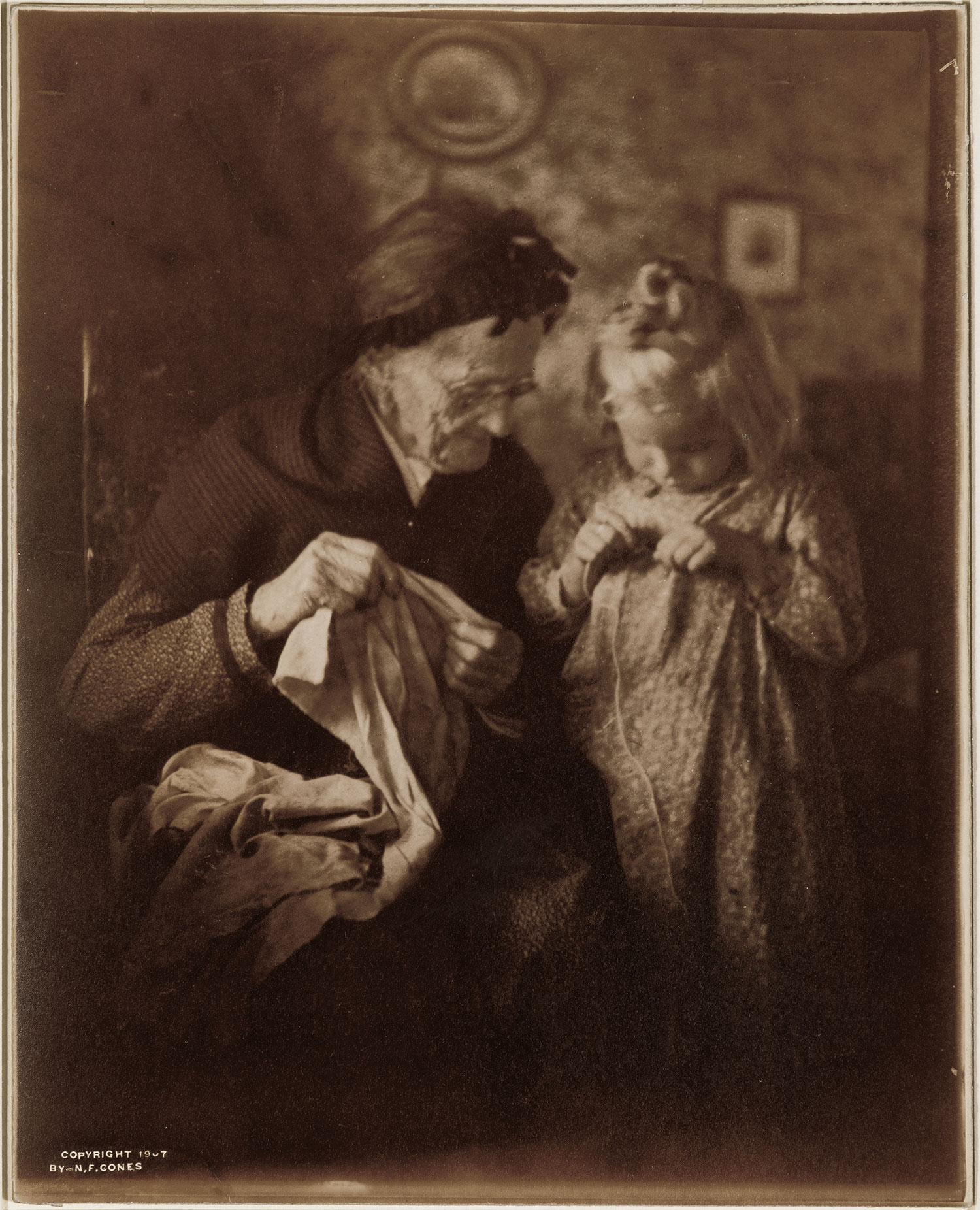 Nancy Ford Cones (American, 1869–1962), Threading the Needle or Helping Grandmother Sew, 1905 (printed 1907), gelatin silver print. Dayton Art Institute, Gift of Miss Jane Reece, 1952.19.495